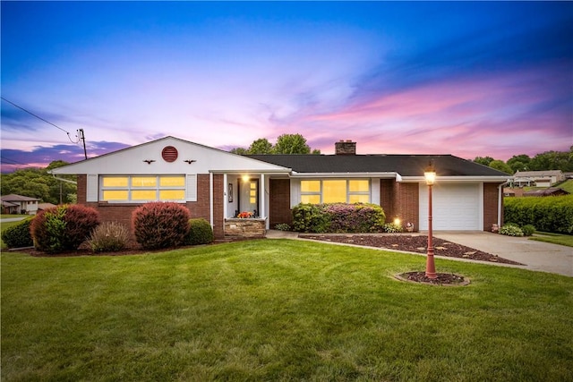 ranch-style house with brick siding, an attached garage, driveway, a front yard, and a chimney