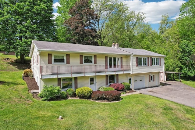 townhome / multi-family property with asphalt driveway, a chimney, a front lawn, and a garage