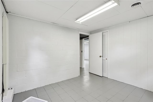 unfurnished room with concrete block wall