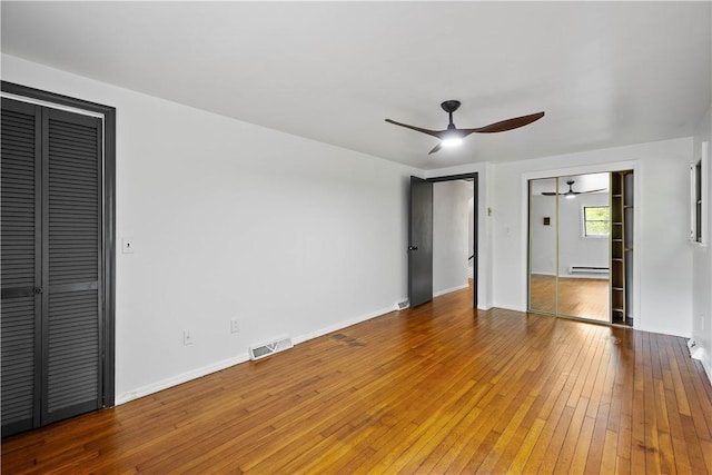 2710 Douglas Run Rd, Elizabeth Twp/Boro, PA 15037 - unfurnished bedroom featuring a baseboard heating unit, hardwood / wood-style floors, baseboards, and ceiling fan