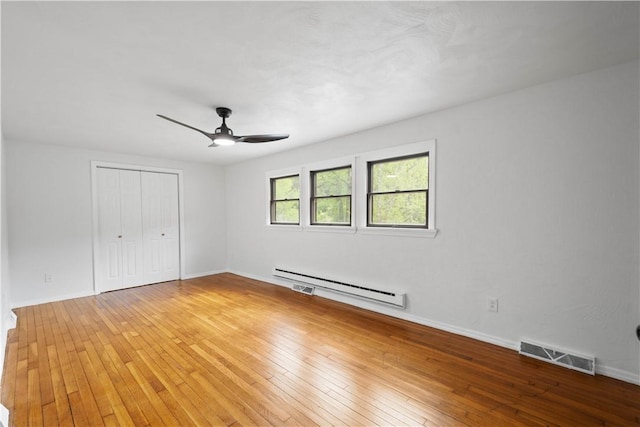 2710 Douglas Run Rd, Elizabeth Twp/Boro, PA 15037 - unfurnished bedroom featuring a baseboard heating unit, light wood-style flooring, a closet, baseboards, and ceiling fan