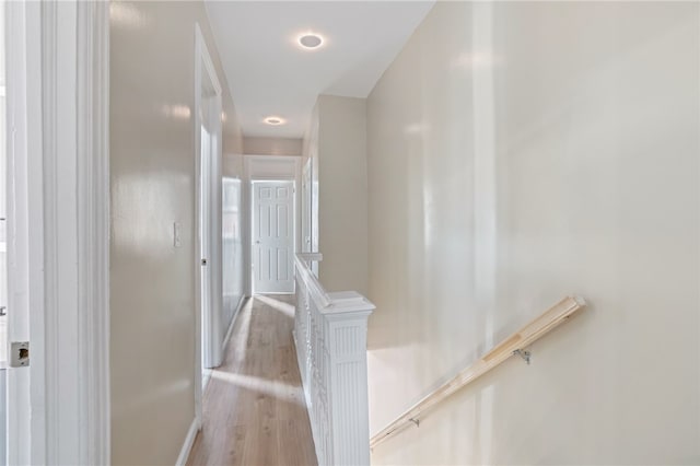 staircase featuring wood finished floors and baseboards