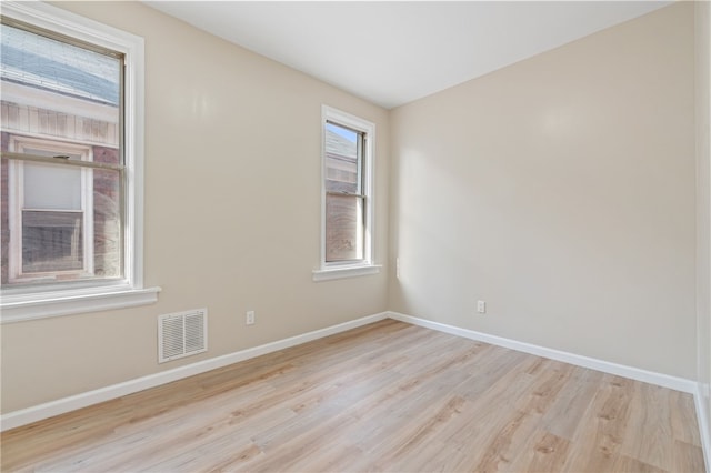 unfurnished room featuring wood finished floors and baseboards