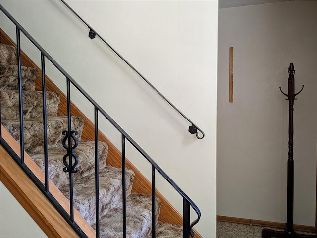 staircase featuring baseboards