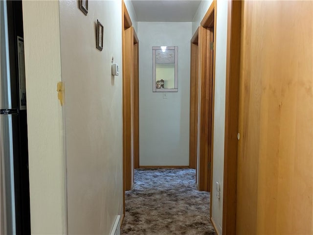 hallway featuring carpet floors and baseboards