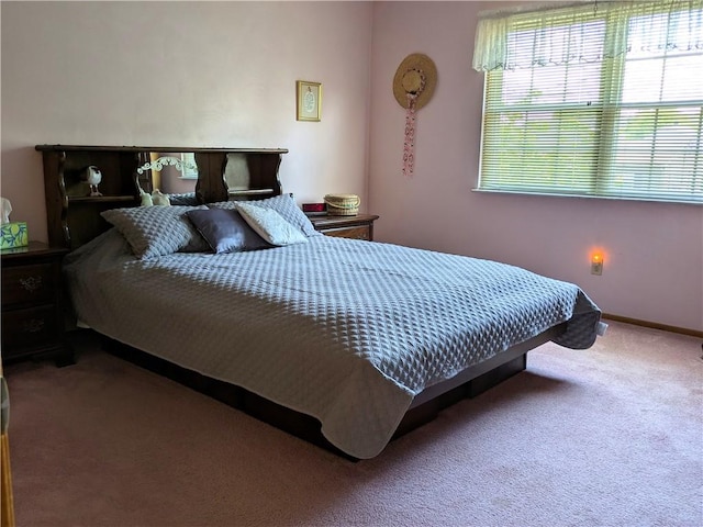 bedroom with carpet floors and baseboards