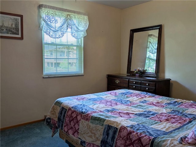 carpeted bedroom featuring multiple windows and baseboards