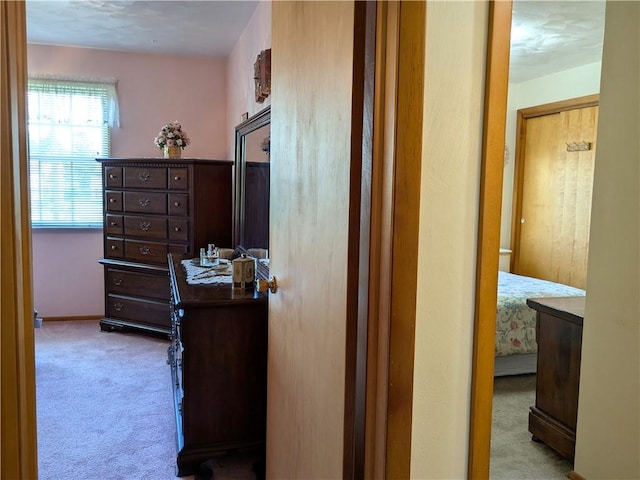 corridor featuring carpet and baseboards