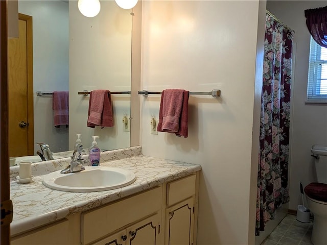 bathroom featuring toilet, vanity, tile patterned flooring, and a shower with curtain