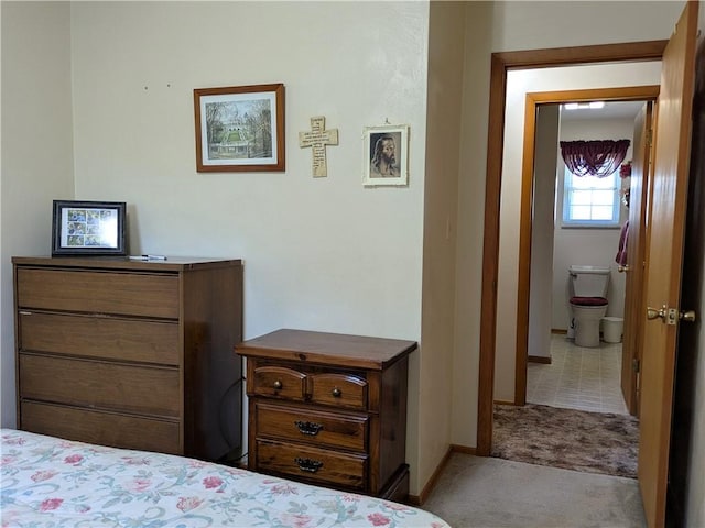 bedroom featuring carpet flooring, baseboards, and ensuite bathroom