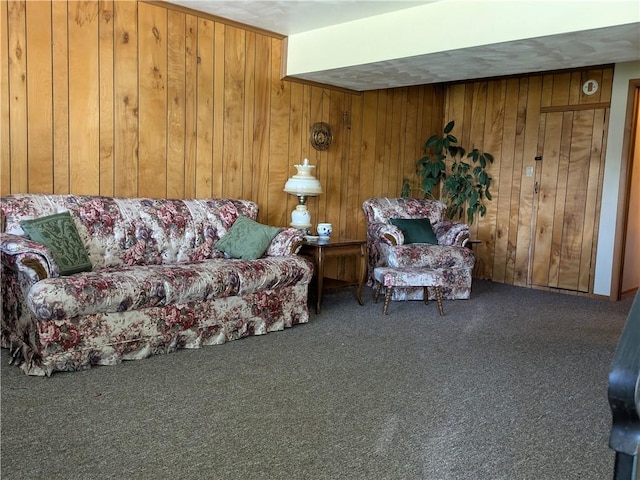 carpeted living room with wood walls