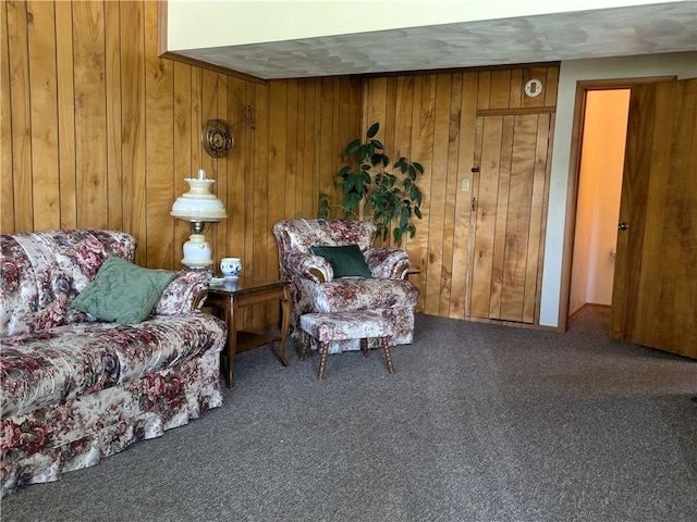 living room featuring wood walls and carpet