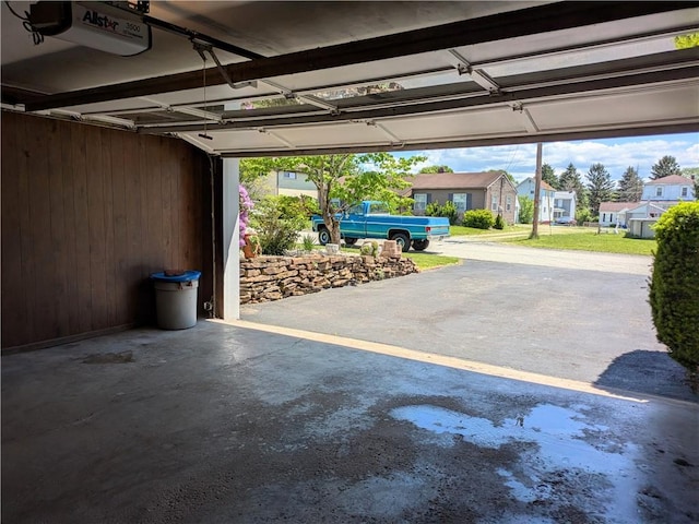 garage with a garage door opener and a residential view