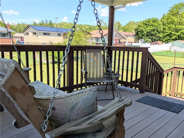 wooden deck with a residential view and a yard
