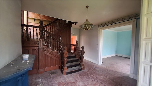 stairs featuring a chandelier, wood finished floors, and baseboards