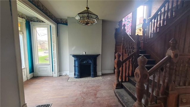 stairway with a chandelier and baseboards