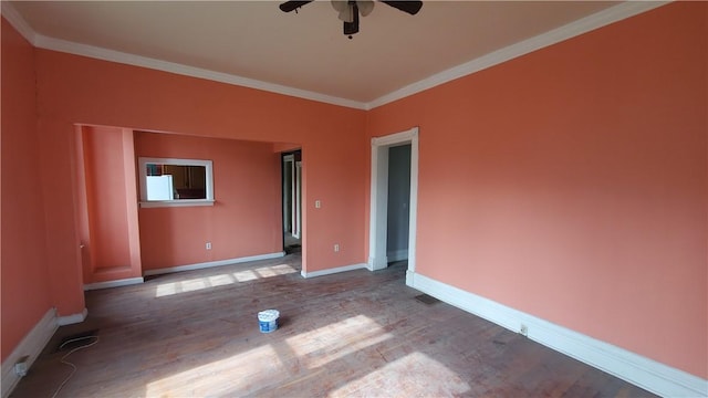 spare room with ceiling fan, baseboards, wood finished floors, and crown molding