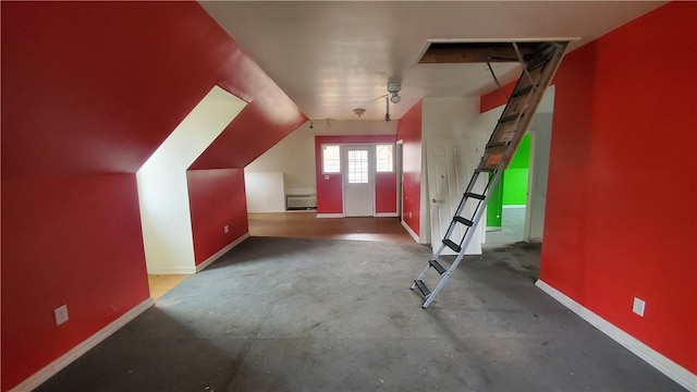bonus room with baseboards and lofted ceiling