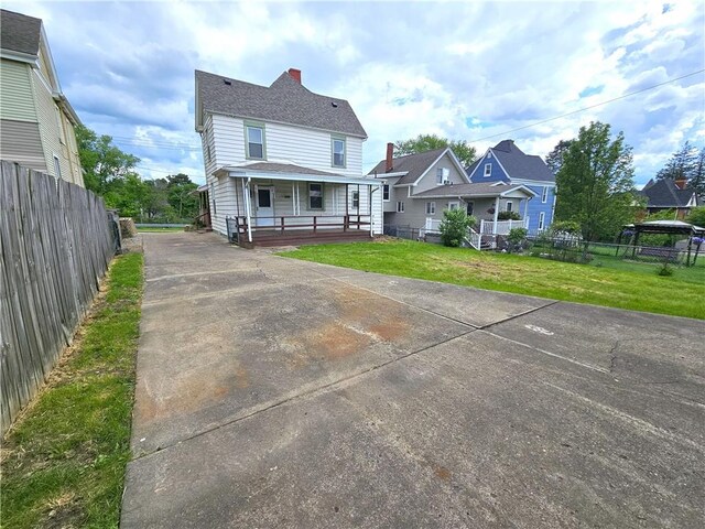 133 Wellington Ave, City Of Washington, PA 15301 - view of front facade with a porch, driveway, and a chimney