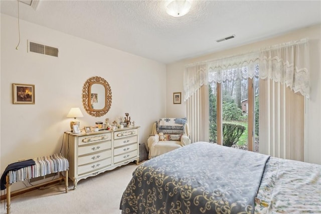 carpeted bedroom featuring a textured ceiling