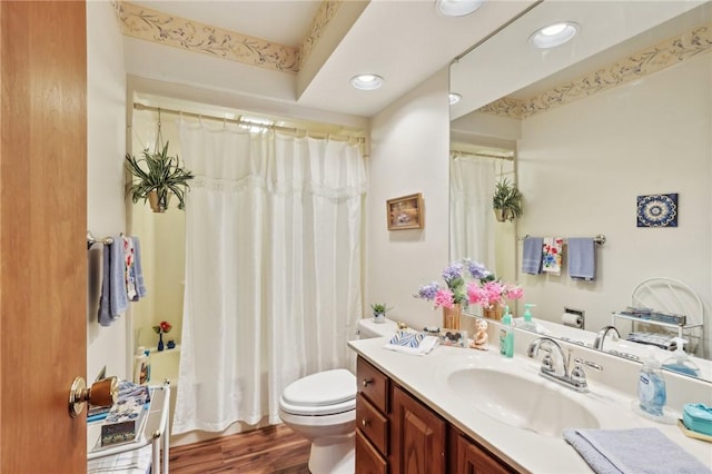 full bath with toilet, recessed lighting, vanity, wood finished floors, and shower / bathtub combination with curtain