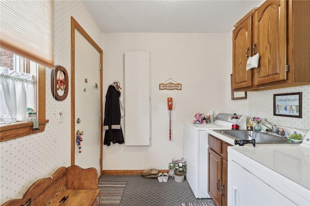 washroom with cabinet space, wallpapered walls, and baseboards