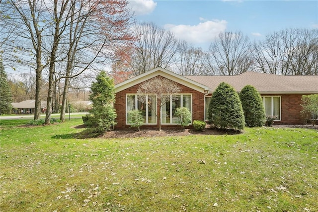 ranch-style home with brick siding and a front lawn
