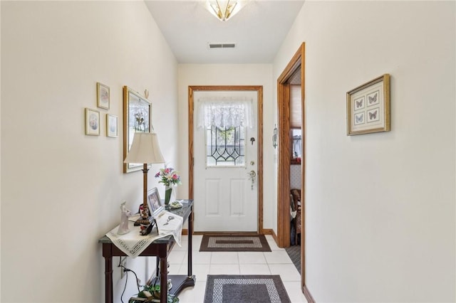 entryway featuring light tile patterned floors and baseboards