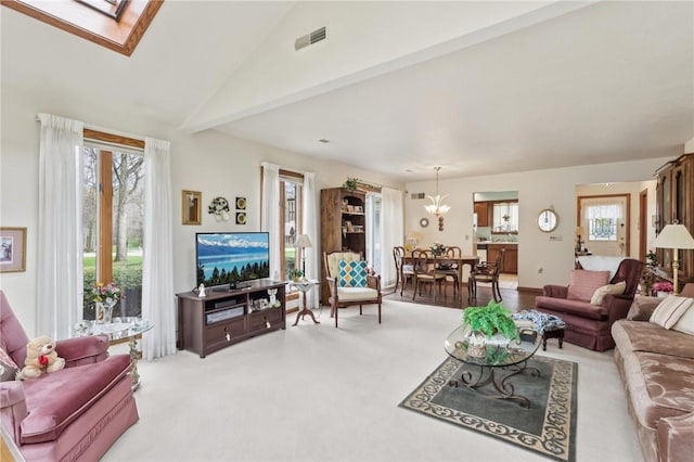 living area featuring carpet, healthy amount of natural light, and a skylight