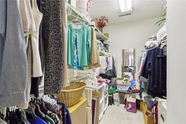 walk in closet with carpet