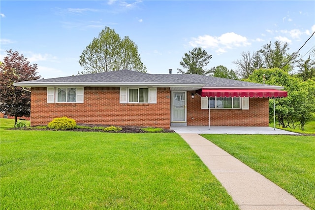 ranch-style home with a front yard and brick siding