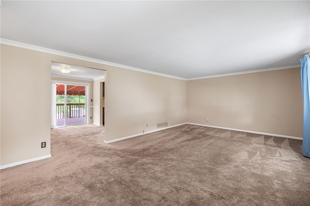 unfurnished room with ornamental molding, carpet floors, and baseboards