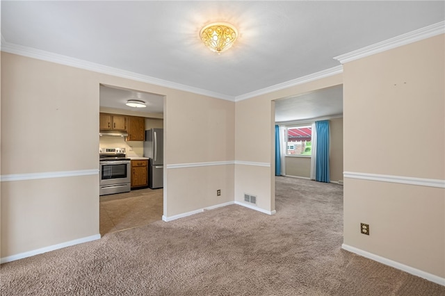 spare room featuring light carpet, crown molding, and baseboards