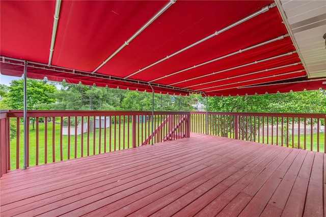wooden terrace featuring a yard