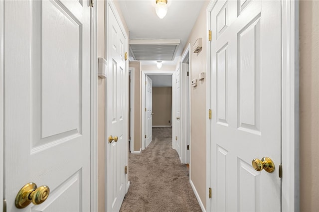 hall with carpet floors and baseboards