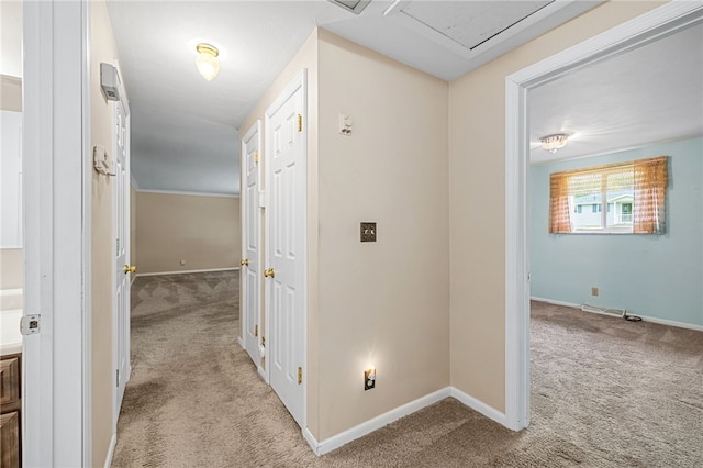 corridor featuring carpet and baseboards