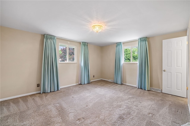 empty room with carpet and baseboards