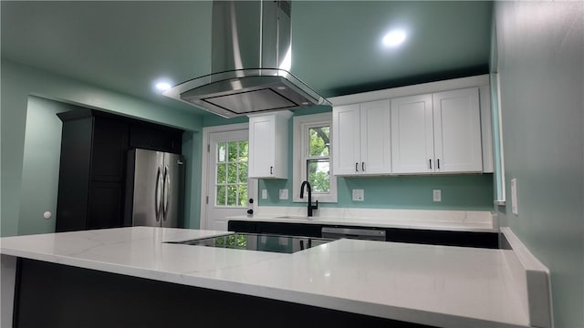7709 Mark Dr, Penn Hills, PA 15147 - kitchen with freestanding refrigerator, island exhaust hood, a sink, black electric stovetop, and white cabinets