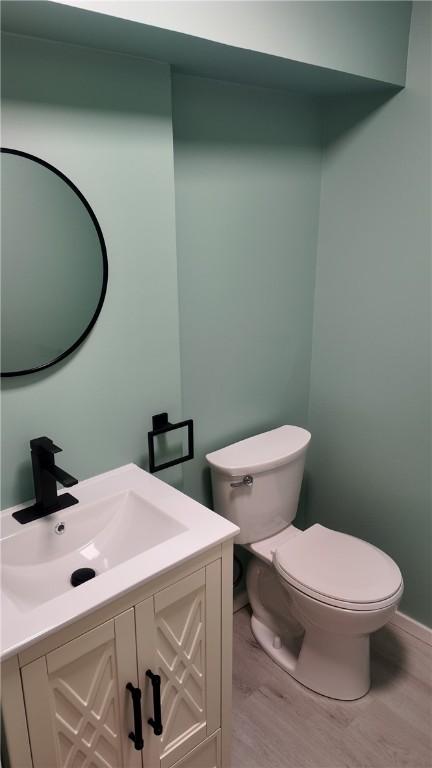 7709 Mark Dr, Penn Hills, PA 15147 - bathroom featuring toilet, wood finished floors, and vanity