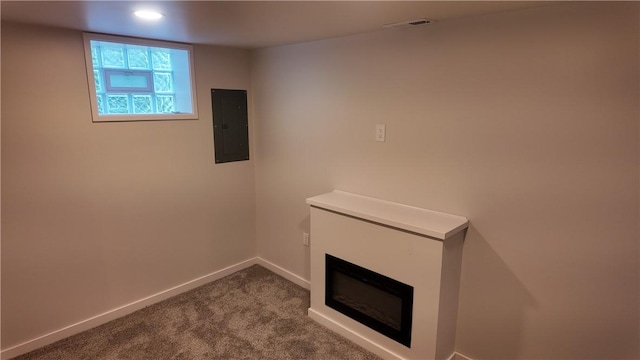 7709 Mark Dr, Penn Hills, PA 15147 - basement featuring electric panel, baseboards, carpet floors, a glass covered fireplace, and recessed lighting