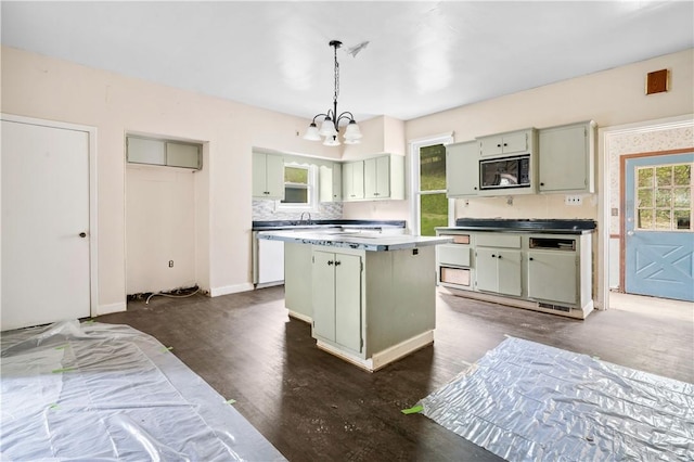 1035 Rte 130, City Of Greensburg, PA 15601 - kitchen featuring black microwave, a chandelier, dark wood-style flooring, a kitchen island, and pendant lighting