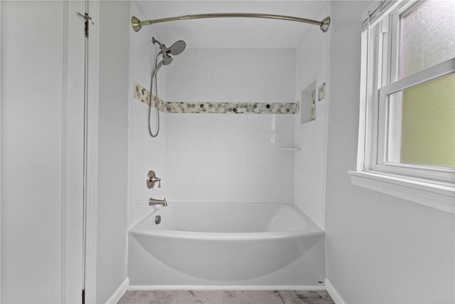 full bathroom with baseboards, healthy amount of natural light, and  shower combination