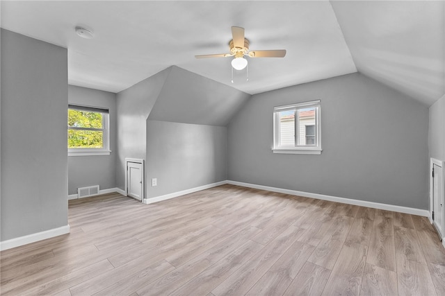 additional living space featuring a ceiling fan, wood finished floors, vaulted ceiling, and baseboards