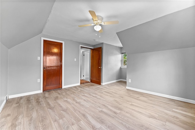 bonus room with lofted ceiling, ceiling fan, light wood finished floors, and baseboards