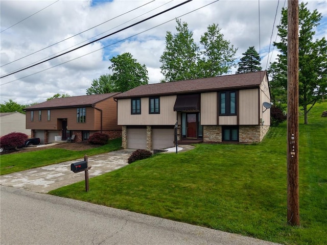 split foyer home with a garage, concrete driveway, and a front yard