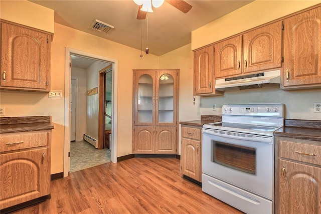 kitchen with white electric range, under cabinet range hood, dark countertops, a baseboard radiator, and ceiling fan