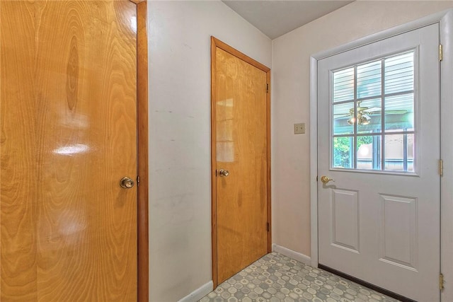 entryway featuring baseboards and light flooring