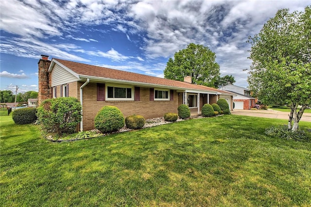 single story home with a chimney, brick siding, a garage, and a front yard