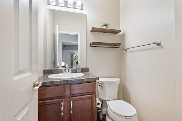 bathroom with toilet and vanity