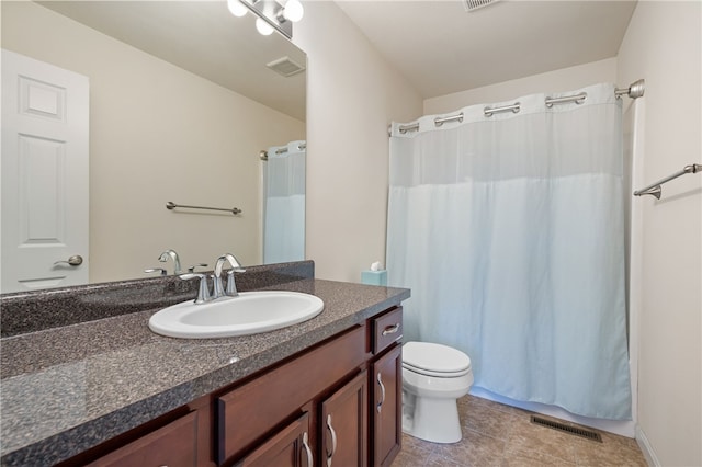 full bathroom featuring toilet, vanity, tile patterned floors, and a shower with curtain